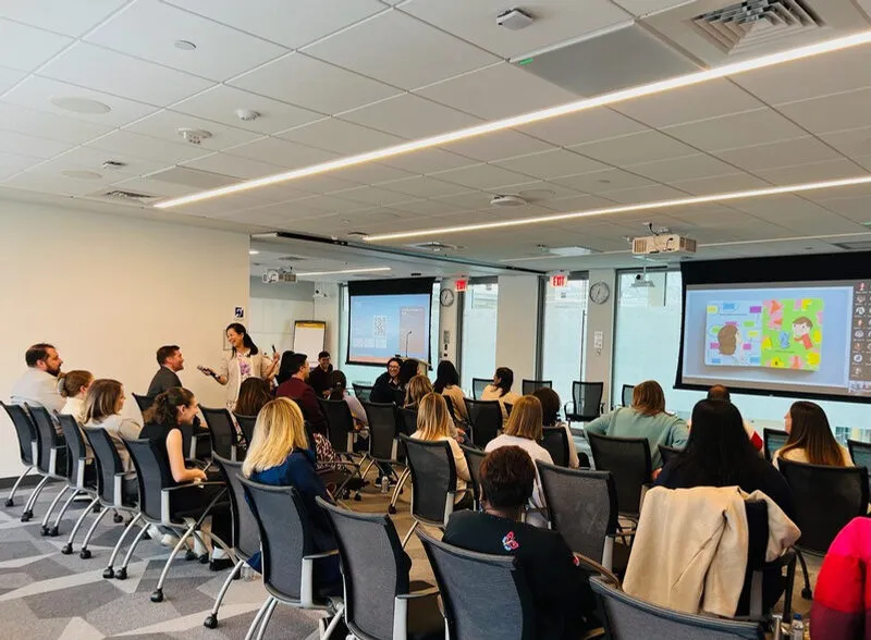 Jossy speaking to employees seated in a company meeting room