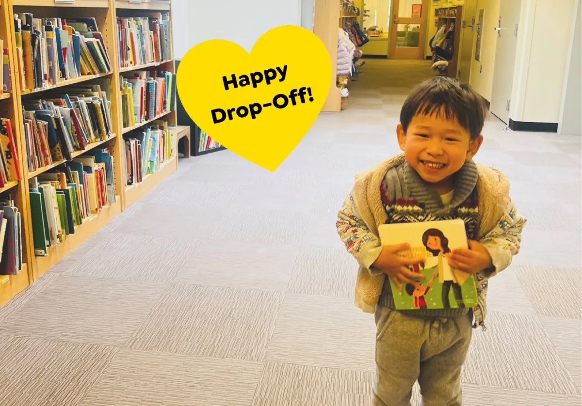 A boy holding the book on his way into school