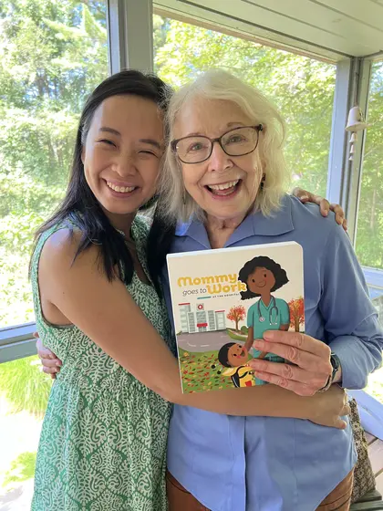 Jossy Lee with a supporter holding the book