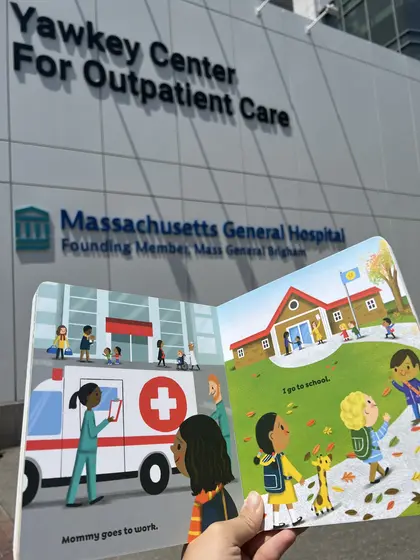 The book open in front of the Yawkey Center for Outpatient Care at Massachusetts General Hospital