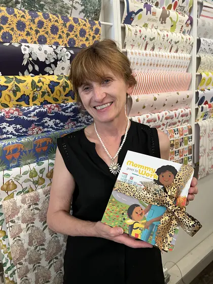 A woman holding the book tied with a gift ribbon