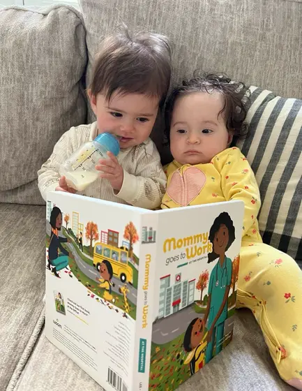 Two babies reading the book together